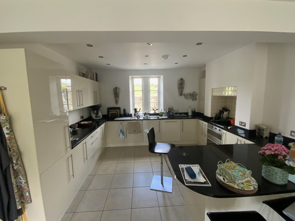 The finished bespoke kitchen showing the different depths inside the cupboards due to the uneven walls behind.